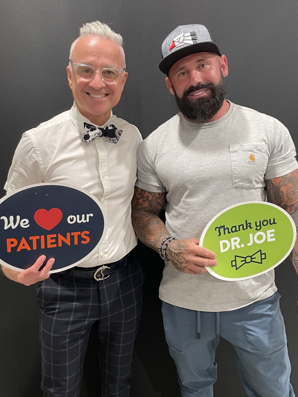 A grateful Aria patient holding a 'Thank you Dr. Joe' sign